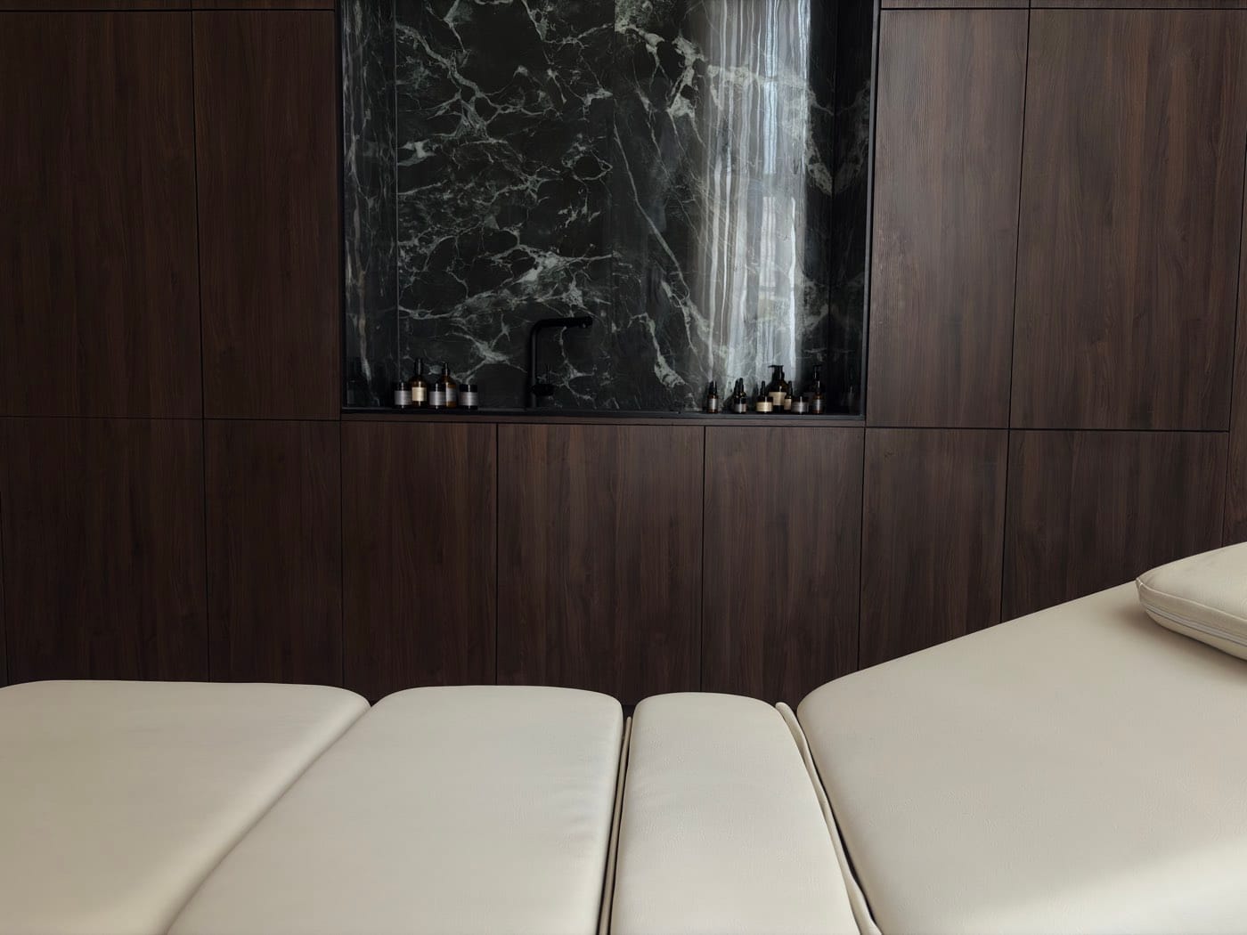 Treatment room with walnut and green marble